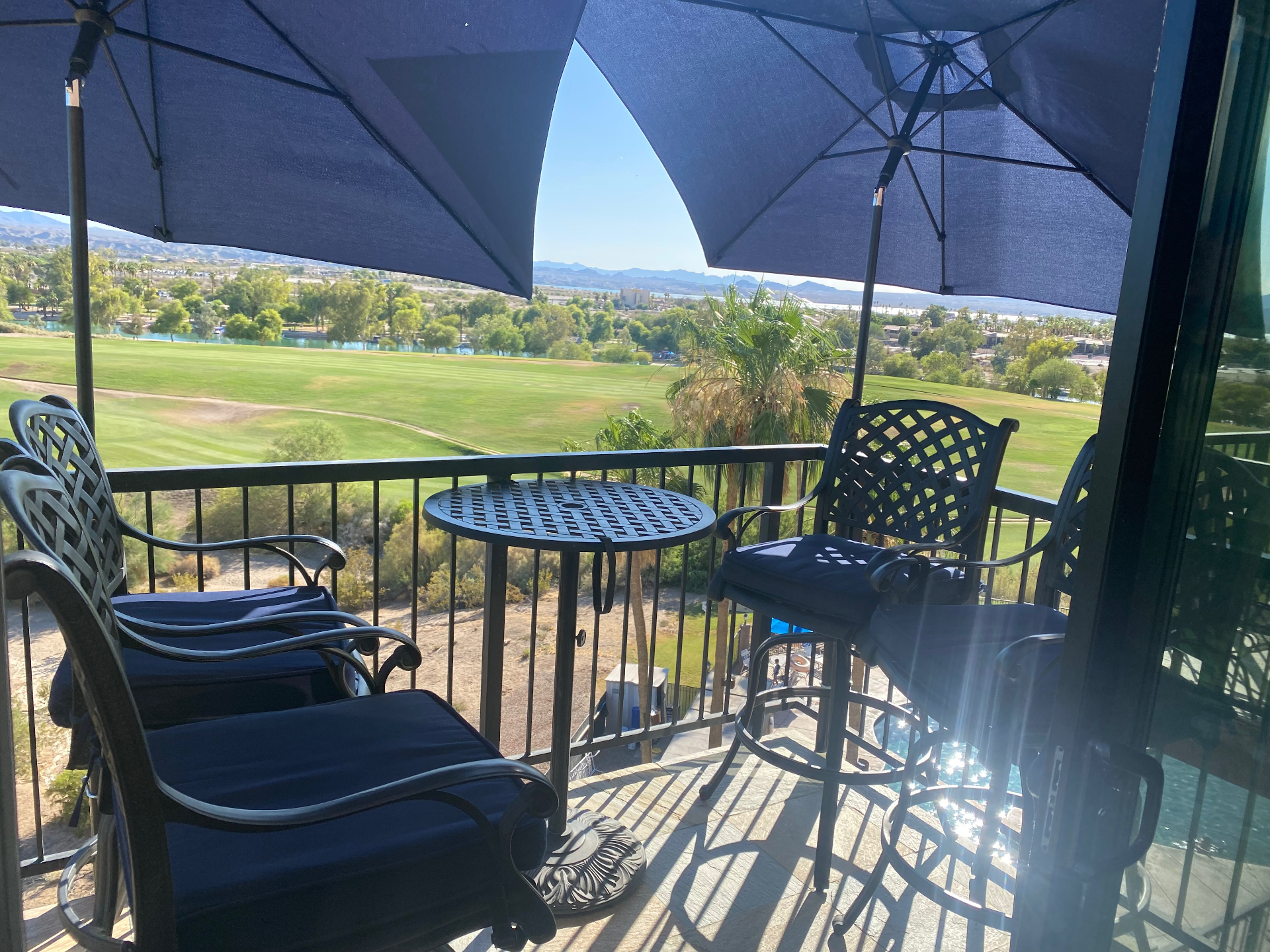 Private balcony with shaded seating overlooking the golf course
