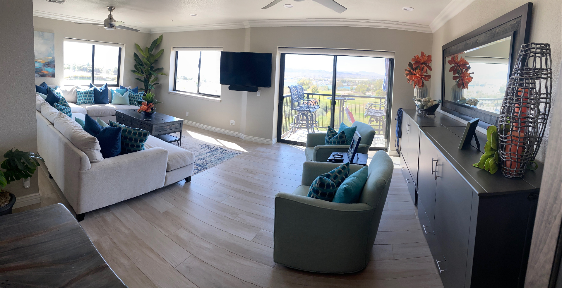 Wide-angle view of the living room opening to the balcony