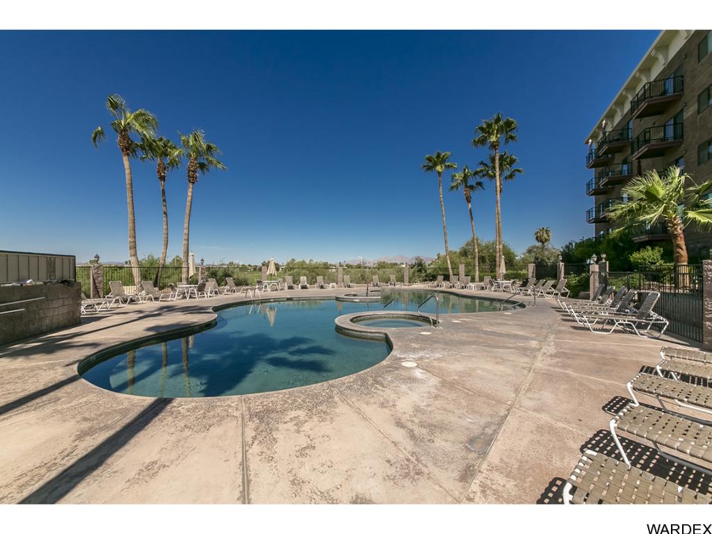 Wide view of the resort pool, spa, and lounge area