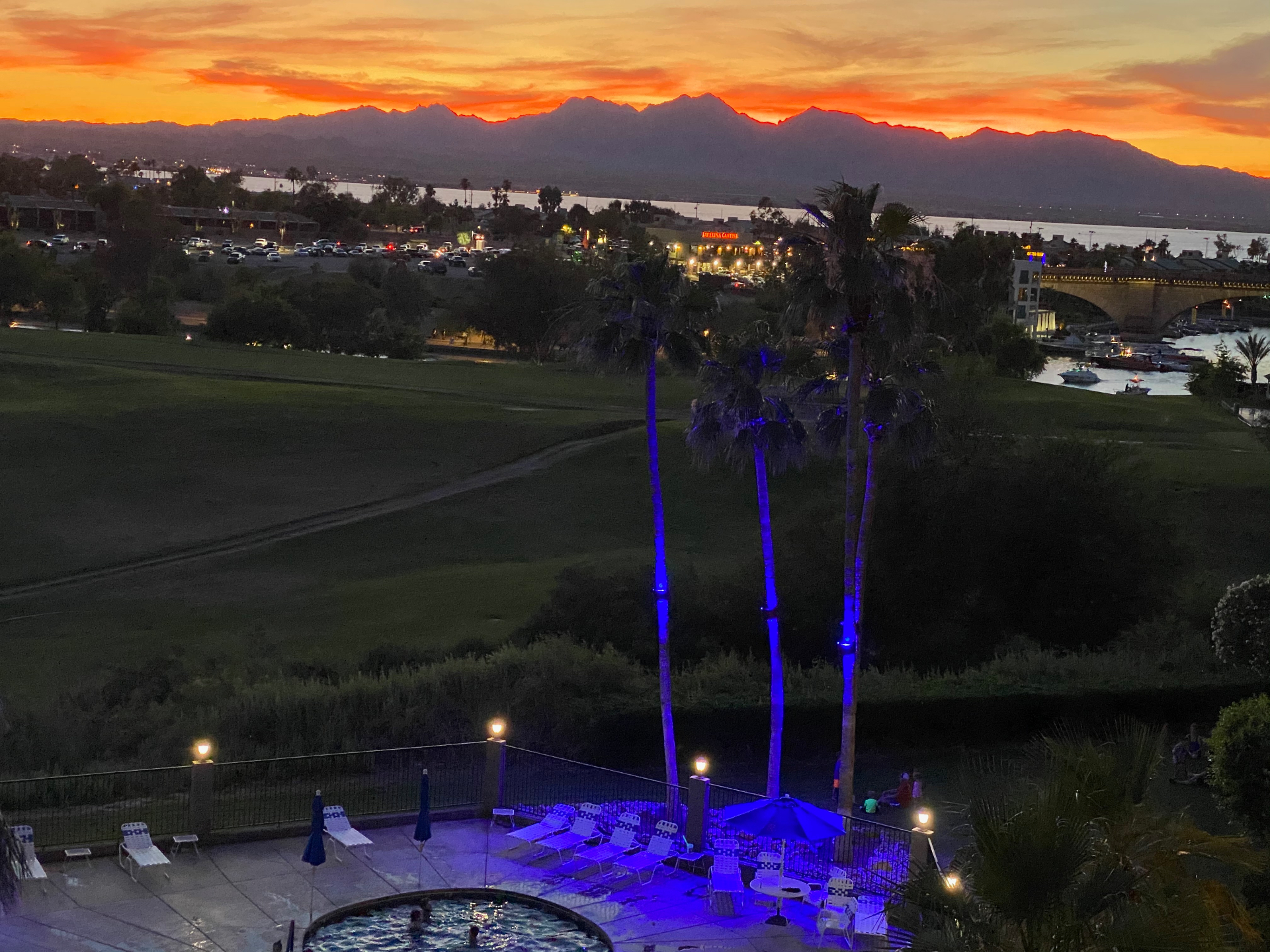 Sunset over the mountains from the balcony with pool below