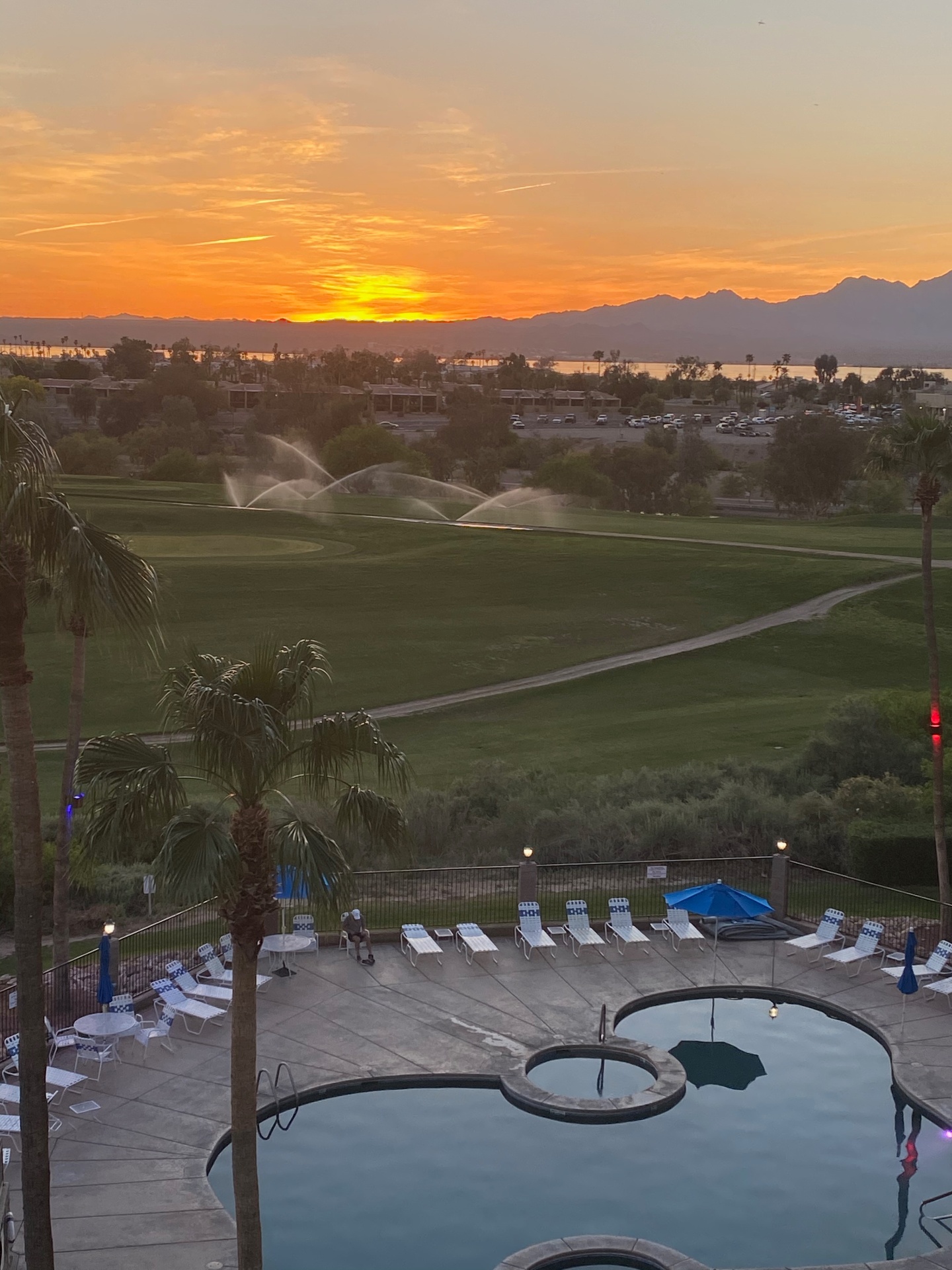 Sunset over Lake Havasu with the golf course and resort pool